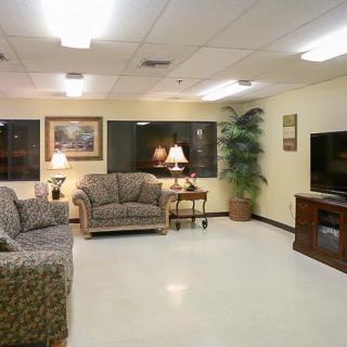 A cozy living room with sofas, a television, and decorative elements.