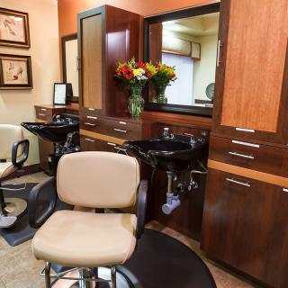 A well-equipped hair salon with chairs and mirrors, ready for clients.