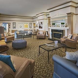 A spacious lobby area with comfortable seating and a fireplace.