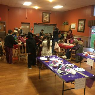 A lively community gathering with various activities and people socializing.
