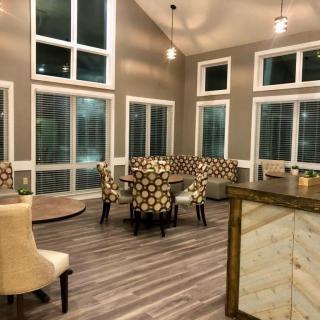 A modern dining area with large windows and stylish furnishings.