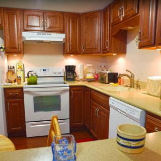 A cozy kitchen with wooden cabinets and modern appliances.