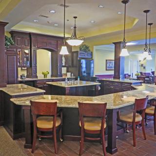 A modern kitchen interior with a spacious countertop and elegant pendant lighting.
