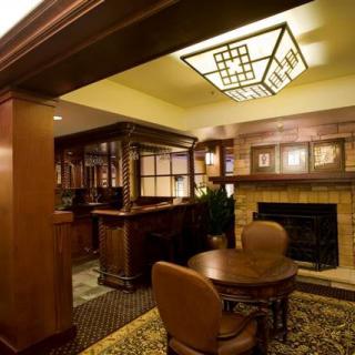 A cozy interior space with wooden furnishings and a fireplace.