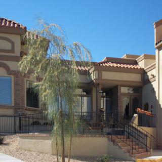 A modern residential building with a well-designed entrance and landscaping.