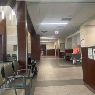 A view of an empty waiting area in a clinic or hospital corridor.