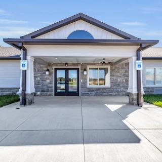 A modern building entrance with stone accents and a welcoming facade.