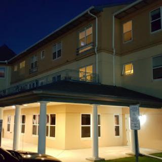 A view of a modern building illuminated at night.