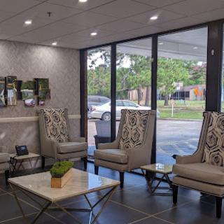 A modern lobby featuring comfortable seating and ample natural light.