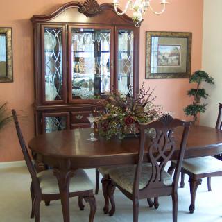 A traditional dining room with ornate furniture and elegant decor.