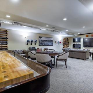 A spacious and well-lit living room with modern furniture and decor.
