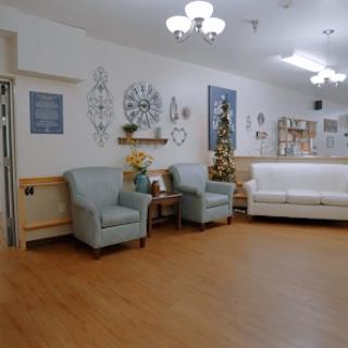 A cozy living space featuring light-colored furniture and decorative elements.