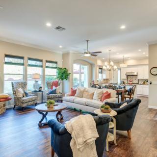 A modern open floor plan living space featuring a cozy seating area and connected kitchen.