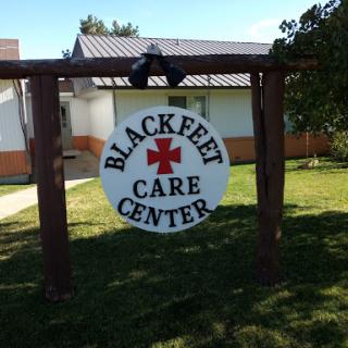 Sign for the Blackfeet Care Center, indicating a healthcare facility in a rural setting.
