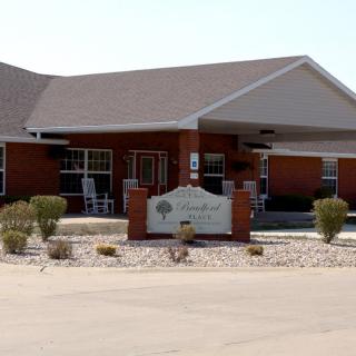 A single-story building with a sheltered entrance and surrounding landscaping.