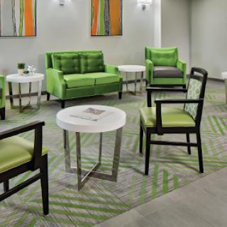 A modern lounge area featuring stylish green furniture and contemporary decor.