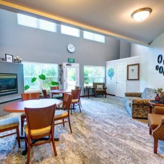 A spacious and well-lit living room with modern furniture and decor.