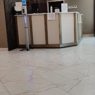 A modern reception area with a sleek counter and elegant flooring.