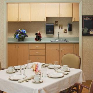 A neatly set dining table in an open kitchen layout.