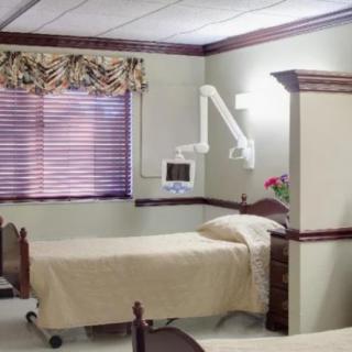 A hospital room with patient beds and medical equipment.