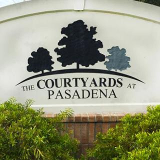 Entrance sign for The Courtyards at Pasadena residential area.