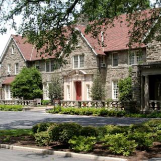 A picturesque stone building surrounded by lush greenery.