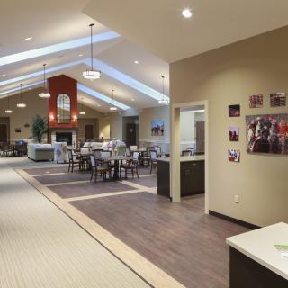 A modern, open-concept dining area with skylights and contemporary furniture.
