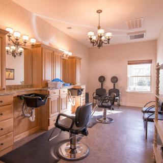 A well-designed salon interior featuring modern styling chairs and elegant lighting.
