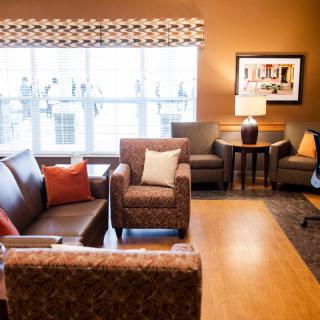 A cozy living room with comfortable seating and warm lighting.