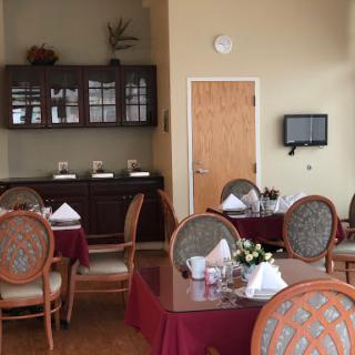 A well-appointed dining area featuring elegant tables and chairs, perfect for intimate gatherings or meals.