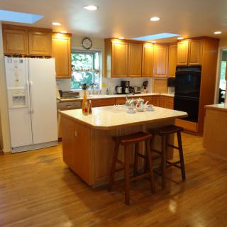 Spacious kitchen with wooden cabinets and a central island.