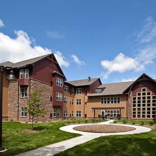 A beautifully designed residential building set against a clear blue sky.