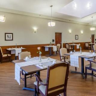 An elegant dining room setup with neatly arranged tables and chairs.