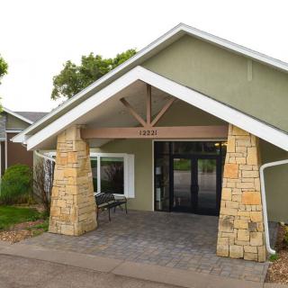 A building entrance with stone pillars and a gabled roof.