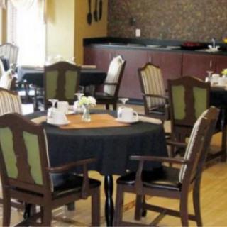 A cozy restaurant dining area with tables and chairs set for service.