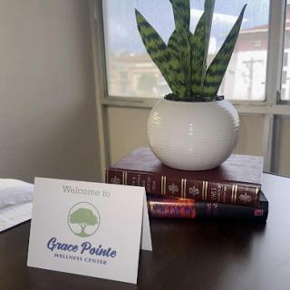 A welcoming setup featuring a stylish plant and books, perfect for an inviting office atmosphere.