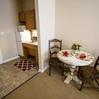 Cozy kitchen and dining area in an apartment with a small table set for two.