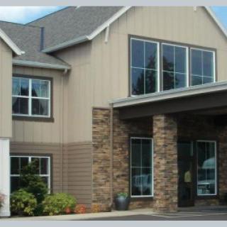 A modern residential building with stone and siding exterior.