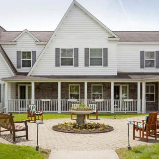 A charming residential house with a garden patio and outdoor seating area.
