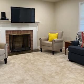 A cozy living room with a fireplace, TV, and comfortable seating.