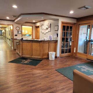 A cozy reception area featuring wooden accents and a welcoming atmosphere.