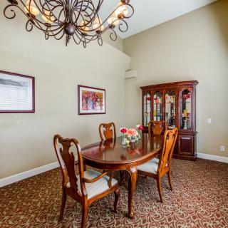 A classic dining room with elegant wooden furniture and a chandelier.