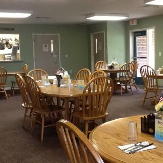 Cozy restaurant dining area with wooden tables and chairs.