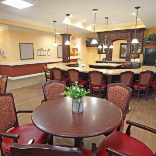 Cozy dining area with a round table and elegant chairs, complemented by warm lighting and tasteful decor.