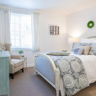 A bright and cozy bedroom with elegant decor and natural lighting.