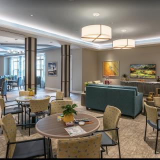 A modern lounge area with comfortable seating, tables, and ambient lighting.