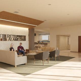 A modern lobby with a seating area and reception desk.