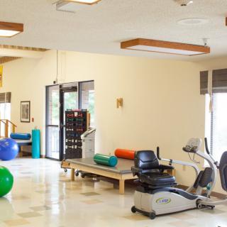 A well-equipped gym or rehabilitation center with exercise machines and fitness equipment.