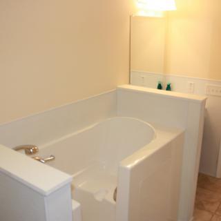 A modern bathroom with a built-in bathtub and soft lighting.