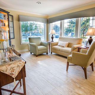 A cozy living room with comfortable seating and large windows allowing natural light.